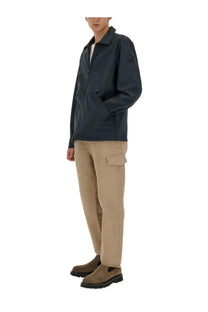 Woolrich men’s dark navy waterproof jacket with subtle logo patch on left sleeve made from durable fabric