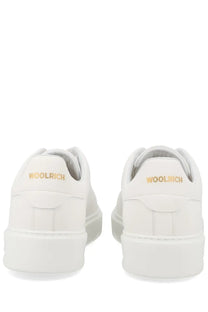 Woolrich men’s sneaker classic court white showing back side with white leather and gold branding on heel