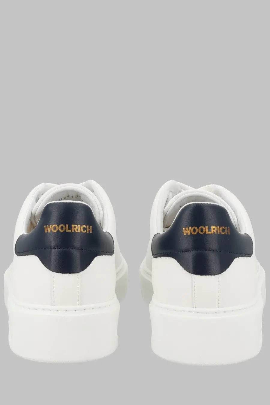 Woolrich men’s classic court sneaker in white wool with navy blue heel tabs and gold lettering shown from the back