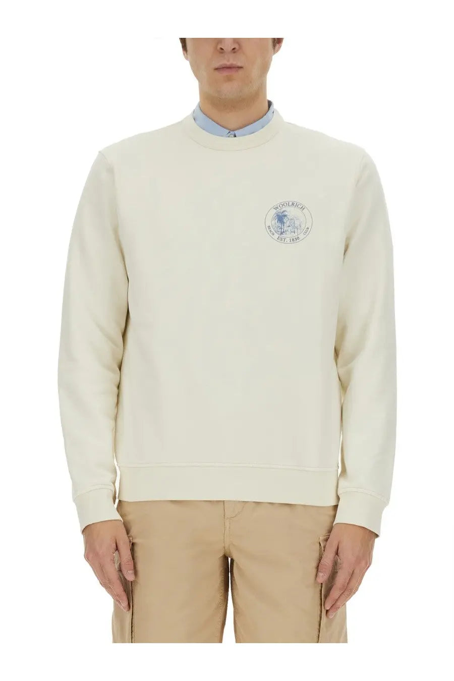 Cream-colored woolrich men’s crewneck sweatshirt made of wool with a blue and white embroidered logo on the chest