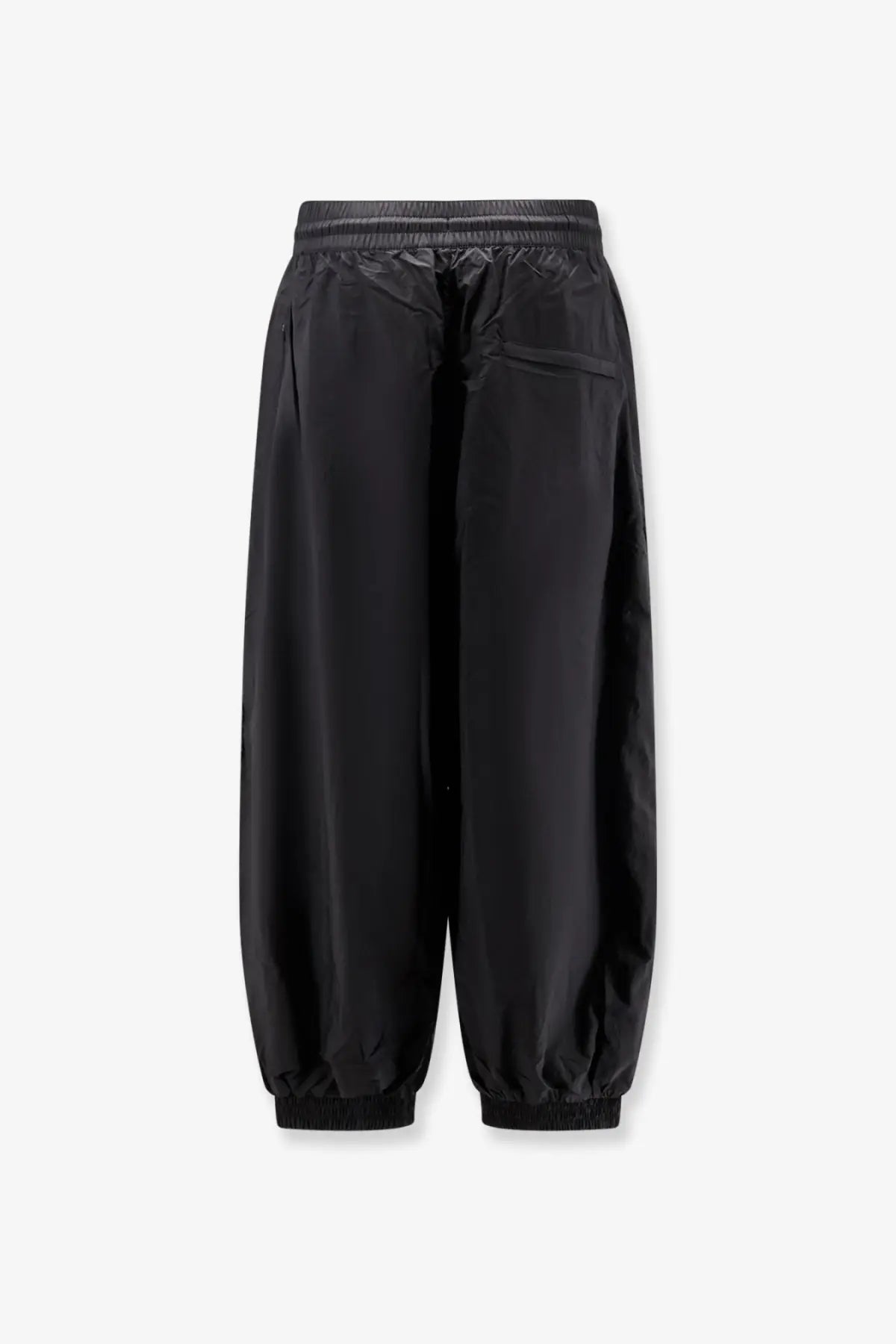 Black y-3 men’s baggy nylon trousers featuring sleek minimalist design with smooth lightweight fabric