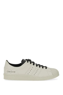 Cream-colored leather y-3 men’s superstar sneaker with black laces and yohji yamamoto logo on the side