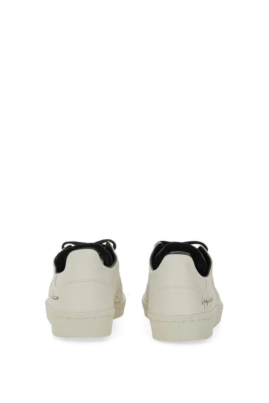 Cream-colored leather y-3 men’s superstar sneaker with black laces and subtle heel branding shown from the back