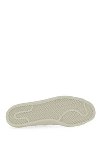 Cream-colored rubber sole with herringbone tread pattern on y-3 men’s superstar sneaker white
