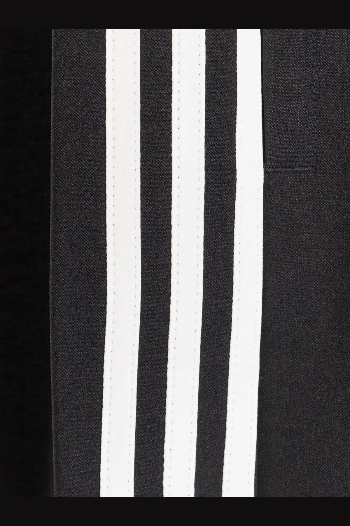 Y-3 men’s wire pants in black recycled polyester with three bold white stripes running vertically along the side