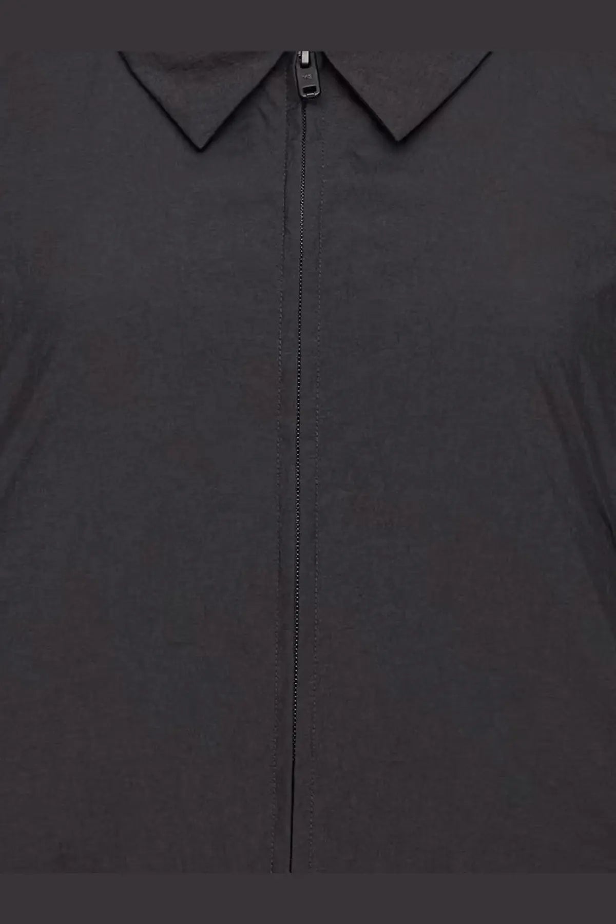 Y-3 women’s black nylon zip-up jacket with structured collar and sleek minimalist design