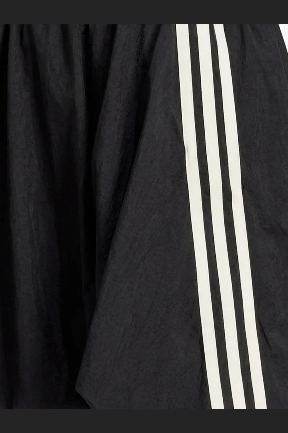 Y-3 women’s black nylon skirt with three bold white stripes on the side made from lightweight textured fabric
