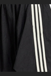 Black y-3 women’s nylon skirt with three bold white stripes down the side made from lightweight textured fabric