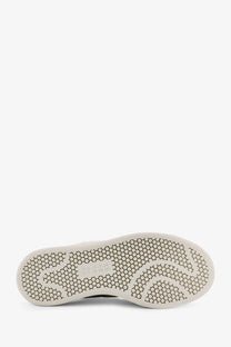 White rubber sole with hexagonal tread and subtle branding on y-3 women’s stan smith velcro leather grey sneakers