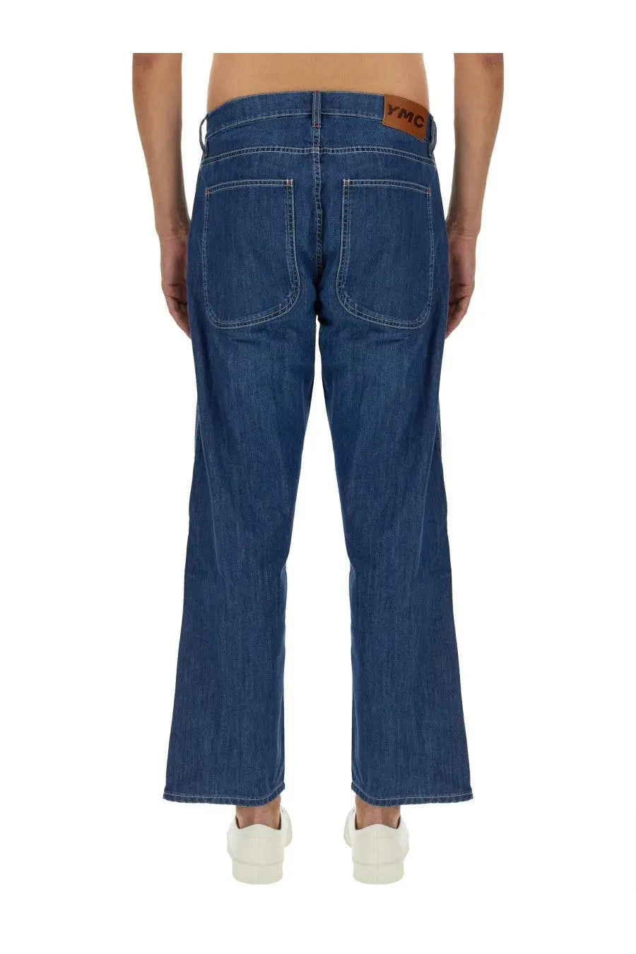 Ymc men’s jeans bez blue showing blue denim fabric with brown leather brand patch at the waistband back view