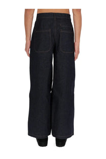 Back view of ymc men’s replacement jeans in dark indigo denim with wide-leg fit and contrasting stitching