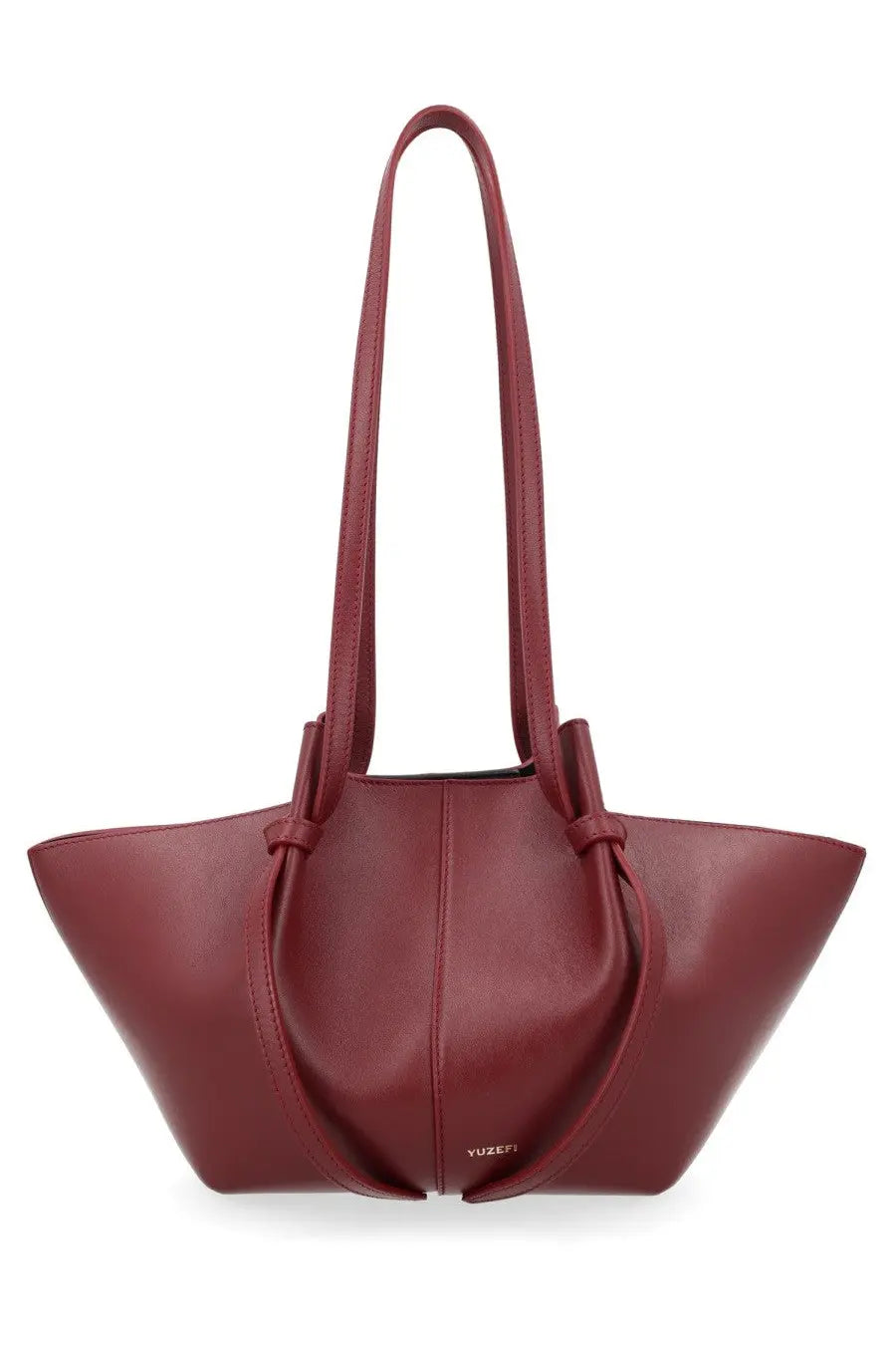 A sleek burgundy leather tote bag with structured soft silhouette and adjustable shoulder straps by Yuzefi
