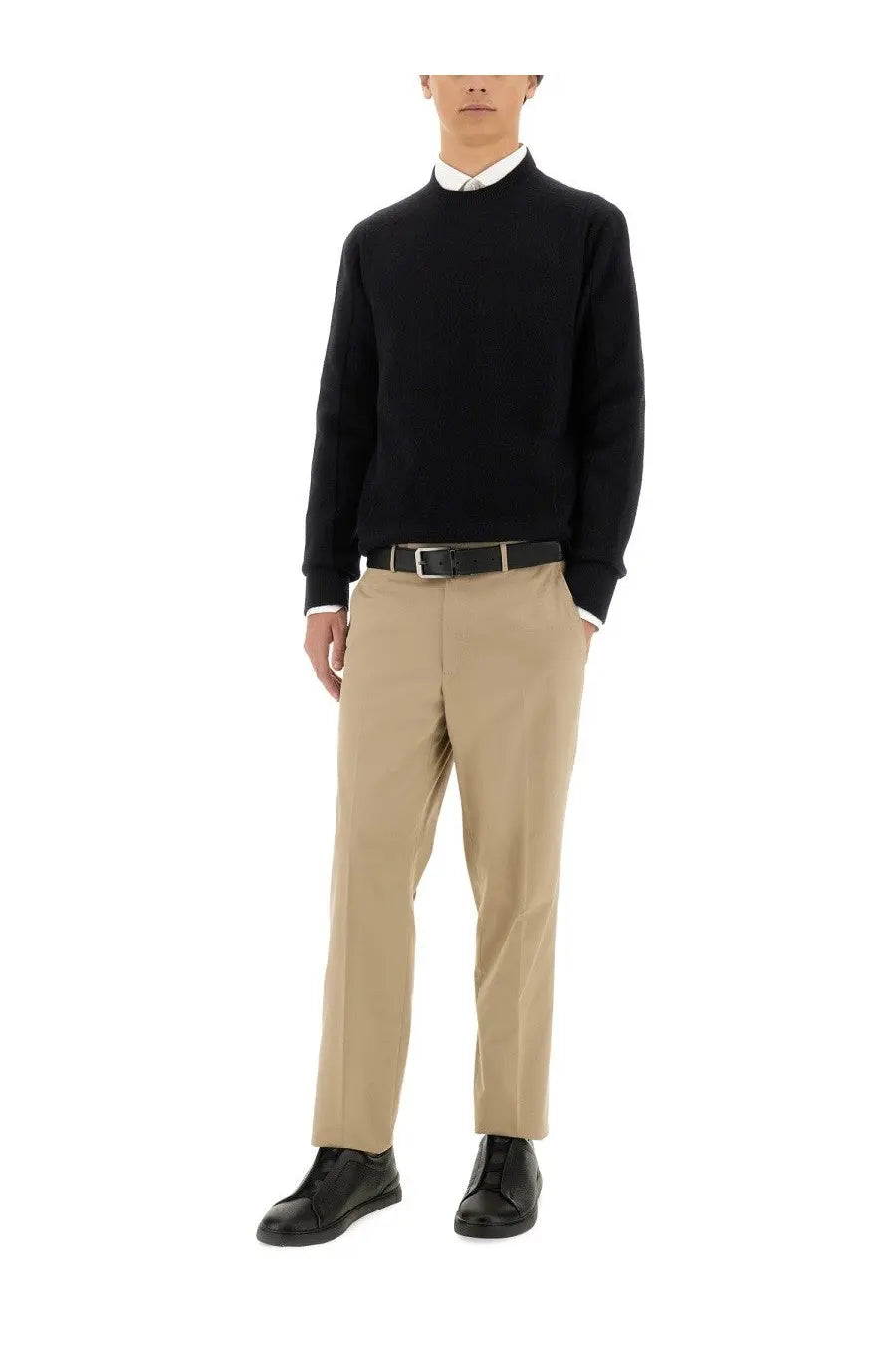 Black ribbed knit sweater with crew neck and long sleeves paired with zegna mens straight leg beige pants