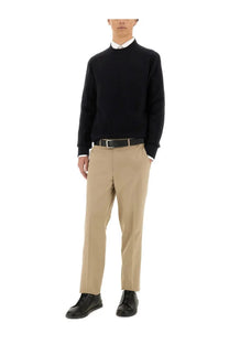 Black ribbed knit sweater with crew neck and long sleeves paired with zegna mens straight leg beige pants