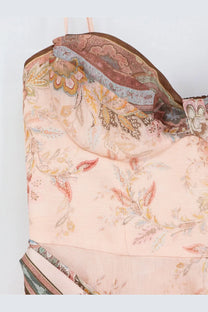 Delicate pink satin corset top with intricate paisley floral pattern and brown trim paired with zimmermann alchemy silk and linen blend midi dress blue