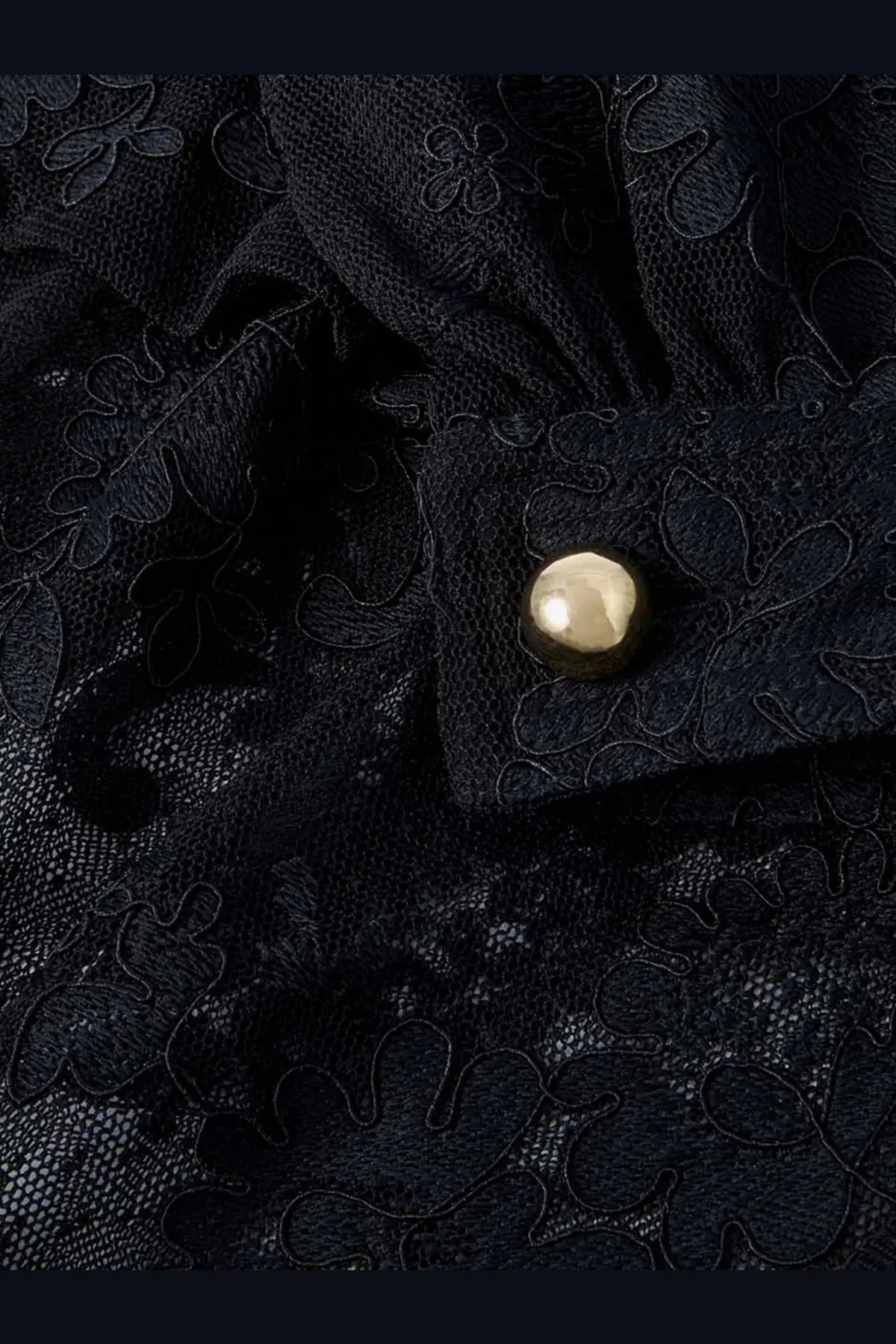 Zimmermann women’s luna lace harem pant black showing round metallic gold button on black floral lace fabric