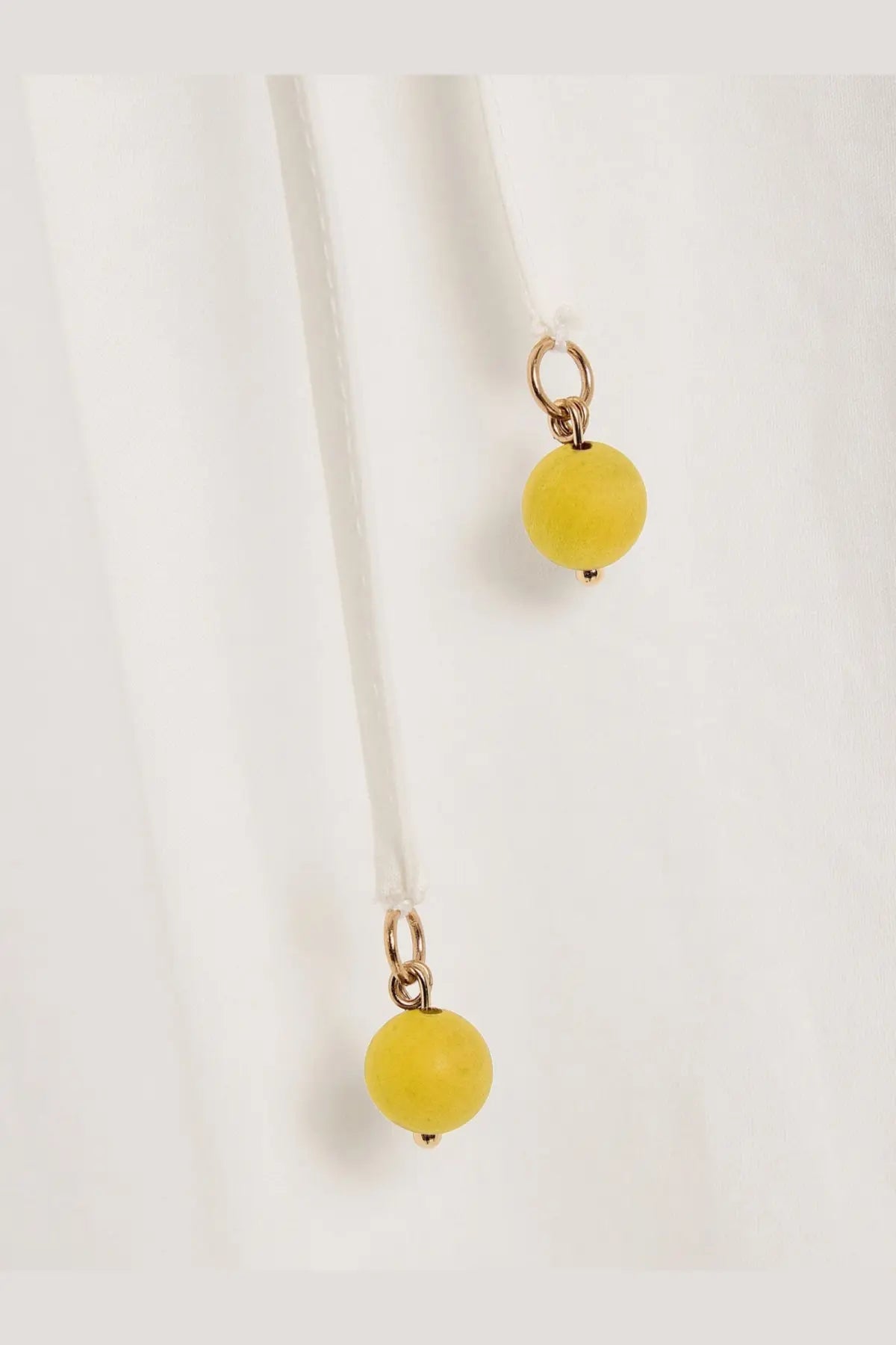 Zimmermann women’s mahon cotton skirt white features yellow spherical bead charms with gold toned metal loops on a white cord