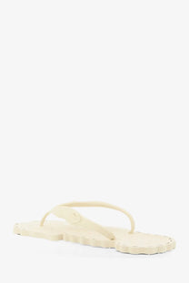 Zimmermann women’s seafoam thong rubber sandal in cream with scalloped edge and simple flip-flop design