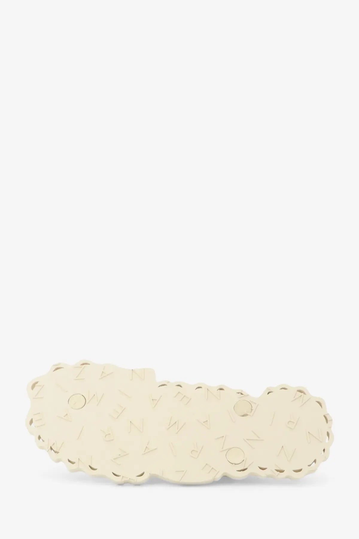 Cream-colored scalloped-edge hair clip with subtle embossed pattern complementing zimmermann seafoam thong sandals white